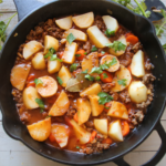 A cozy old-fashioned beef and potato skillet called The Forgotten Supper, featuring tender potatoes, carrots, ground beef, and a rich homemade gravy.