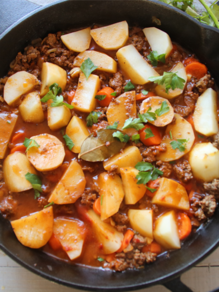 A cozy old-fashioned beef and potato skillet called The Forgotten Supper, featuring tender potatoes, carrots, ground beef, and a rich homemade gravy.
