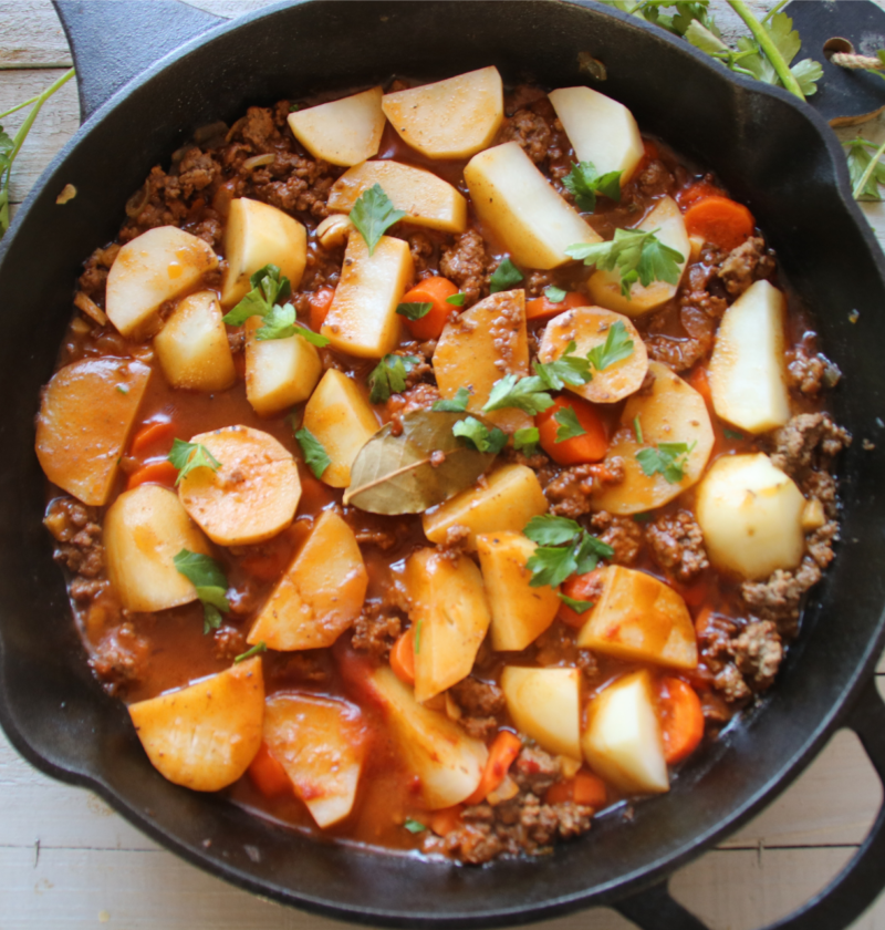 A cozy old-fashioned beef and potato skillet called The Forgotten Supper, featuring tender potatoes, carrots, ground beef, and a rich homemade gravy.
