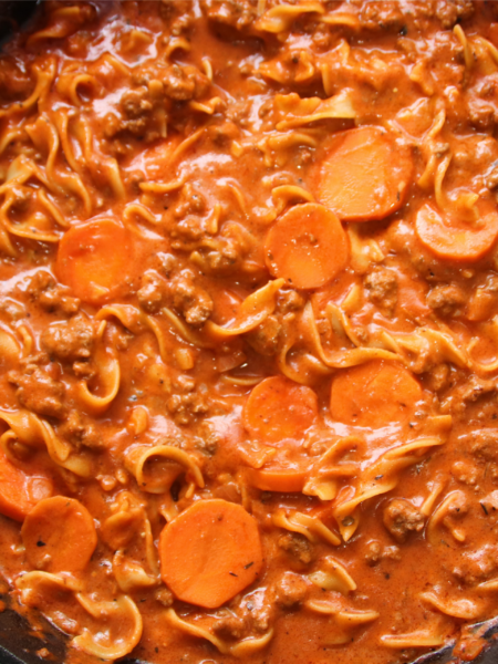 One-pan winter warmer beef and noodles simmering in a cast iron skillet