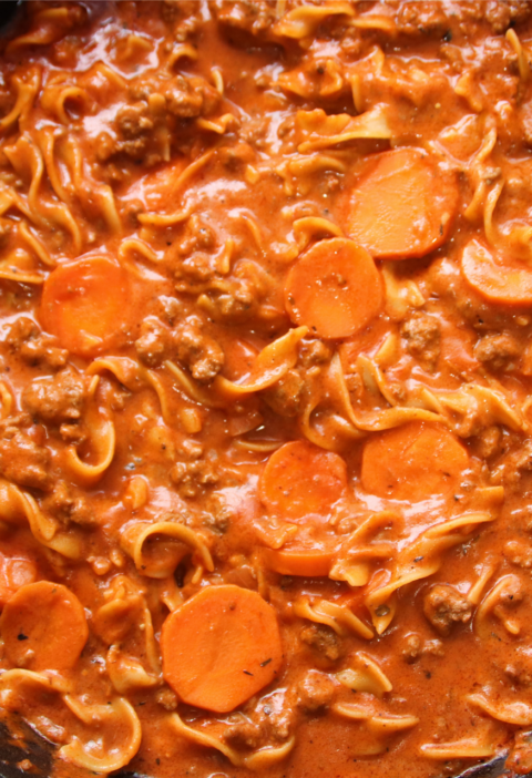 One-pan winter warmer beef and noodles simmering in a cast iron skillet