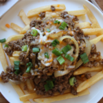 Cheeseburger-style ground beef with melted cheese served over crispy fries