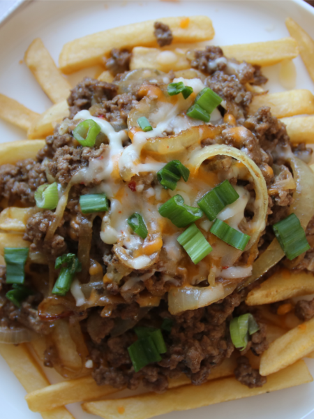 Cheeseburger-style ground beef with melted cheese served over crispy fries