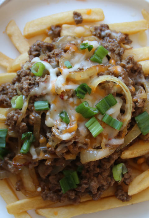 Cheeseburger-style ground beef with melted cheese served over crispy fries