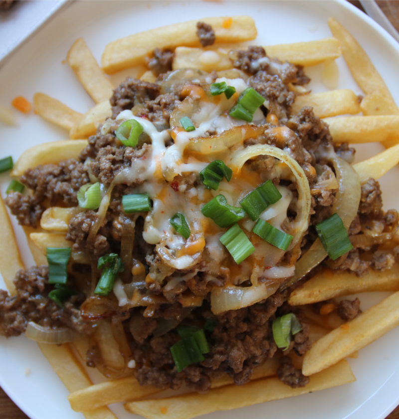 Cheeseburger-style ground beef with melted cheese served over crispy fries