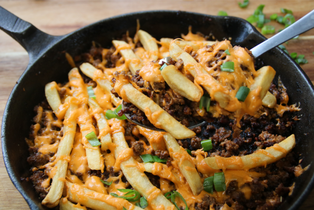 Cheeseburger and fries skillet with melted cheese and crispy fries