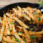 Cheeseburger and fries skillet with melted cheese and crispy fries