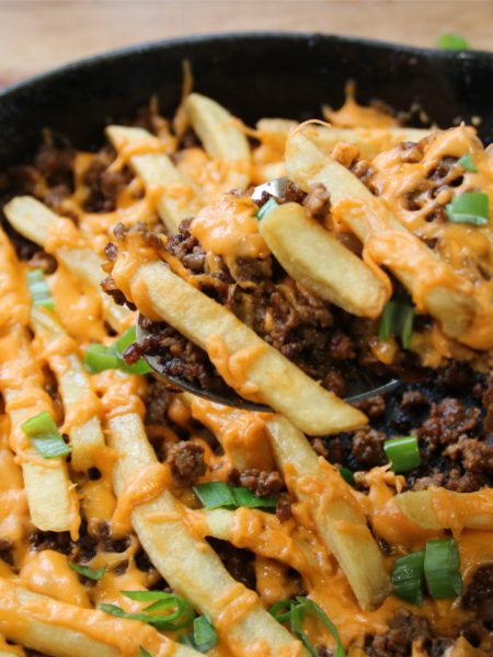 Cheeseburger and fries skillet with melted cheese and crispy fries