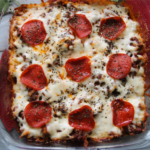 Meat lover's ground beef pizza casserole with penne pasta, pepperoni, and melted mozzarella cheese