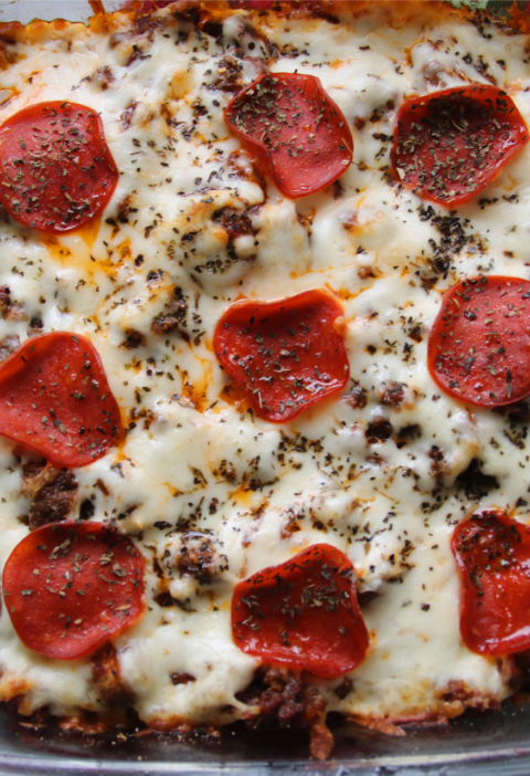 Meat lover's ground beef pizza casserole with penne pasta, pepperoni, and melted mozzarella cheese