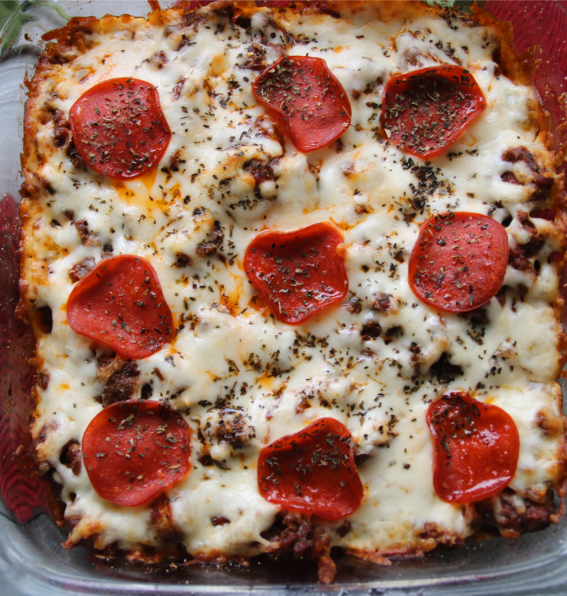 Meat lover's ground beef pizza casserole with penne pasta, pepperoni, and melted mozzarella cheese