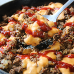 Saucy Ground Beef Skillet topped with creamy cheddar sauce and tangy sauce