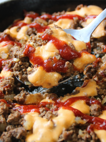 Saucy Ground Beef Skillet topped with creamy cheddar sauce and tangy sauce