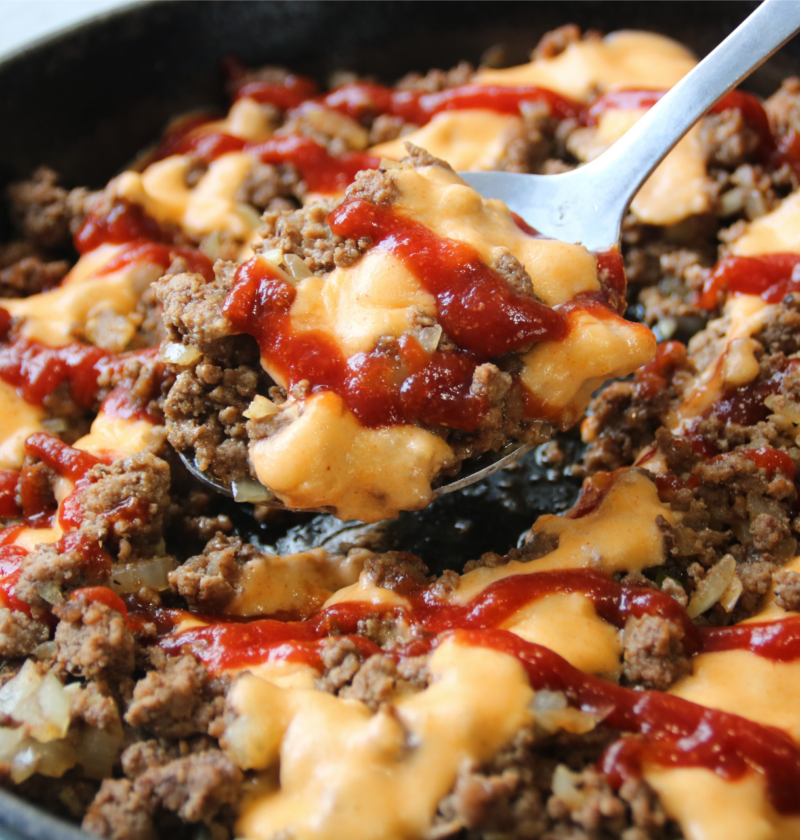 Saucy Ground Beef Skillet topped with creamy cheddar sauce and tangy sauce