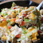 KFC Chicken Burger Skillet served with melted American cheese, burger sauce, lettuce, tomatoes, and toasted sesame buns