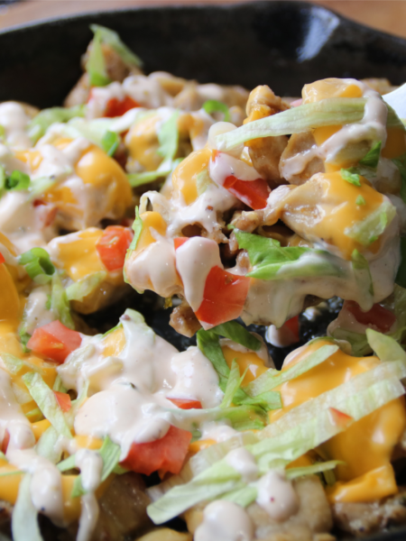KFC Chicken Burger Skillet served with melted American cheese, burger sauce, lettuce, tomatoes, and toasted sesame buns