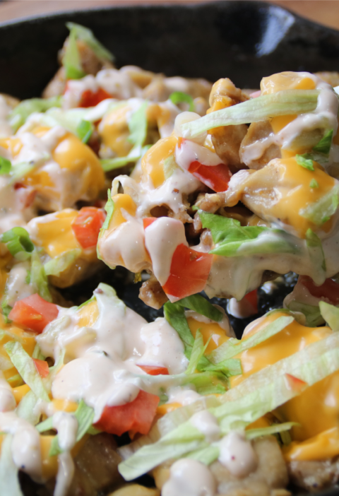 KFC Chicken Burger Skillet served with melted American cheese, burger sauce, lettuce, tomatoes, and toasted sesame buns