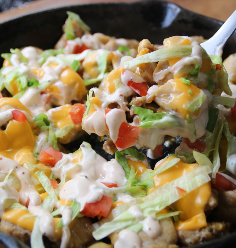 KFC Chicken Burger Skillet served with melted American cheese, burger sauce, lettuce, tomatoes, and toasted sesame buns