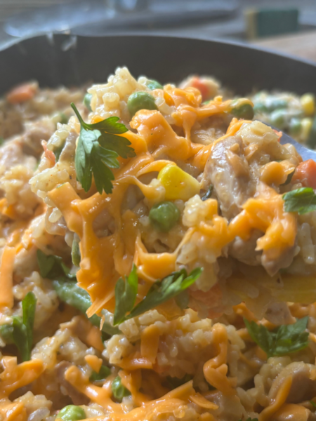 Ole Uncle Joe's Chicken & Rice Supper served in a skillet with tender chicken, fluffy rice, mixed vegetables, and melted cheddar cheese.