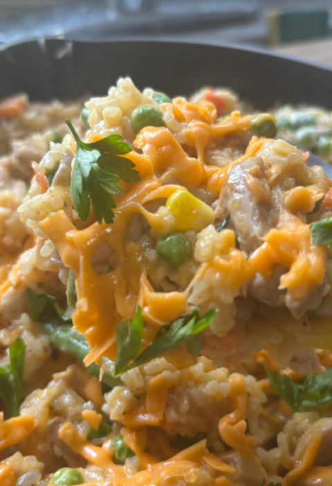 Ole Uncle Joe's Chicken & Rice Supper served in a skillet with tender chicken, fluffy rice, mixed vegetables, and melted cheddar cheese.