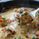 Old Time Creamy Chicken Skillet with tender chicken, crispy bacon, mushrooms, onions, and creamy Parmesan gravy in a cast-iron skillet.