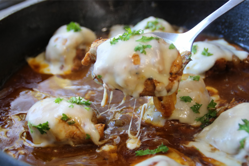 Timeless French Onion Chicken with melted Swiss cheese and caramelized onions in a rich savory gravy
