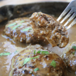 Old-Time Hamburger Steak with Grandpa’s Gravy in a cast-iron skillet