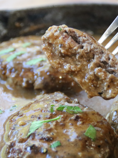 Old-Time Hamburger Steak with Grandpa’s Gravy in a cast-iron skillet