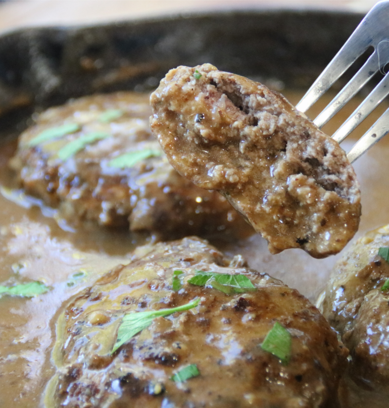 Old-Time Hamburger Steak with Grandpa’s Gravy in a cast-iron skillet