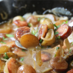 Poor Man’s Sunday Supper with smoked sausage, baby potatoes and onions in rich brown gravy